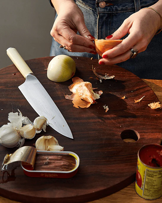 Chef preparing ingredients on a wooden cutting board